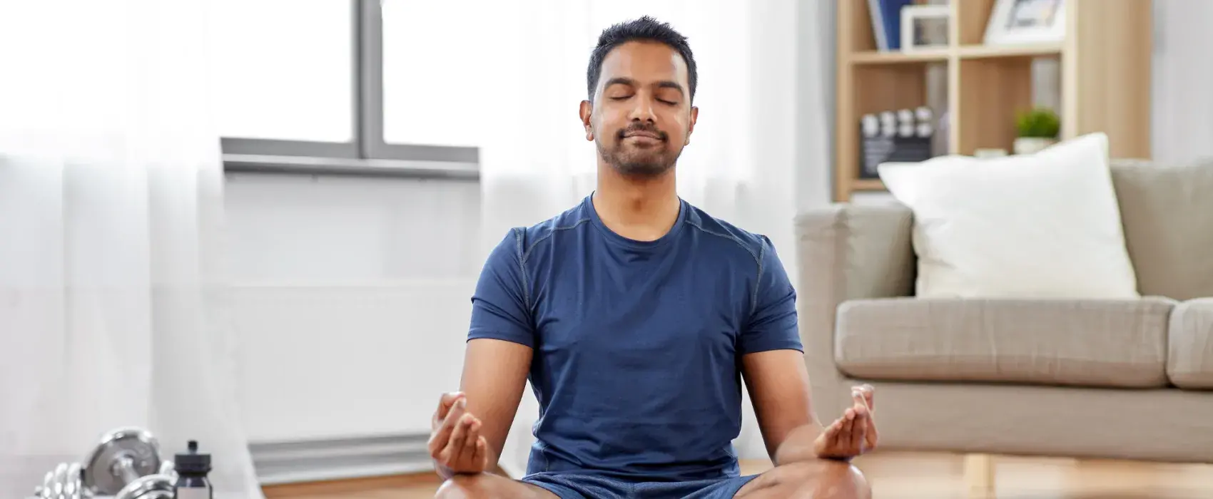 Man meditating on yoga mat