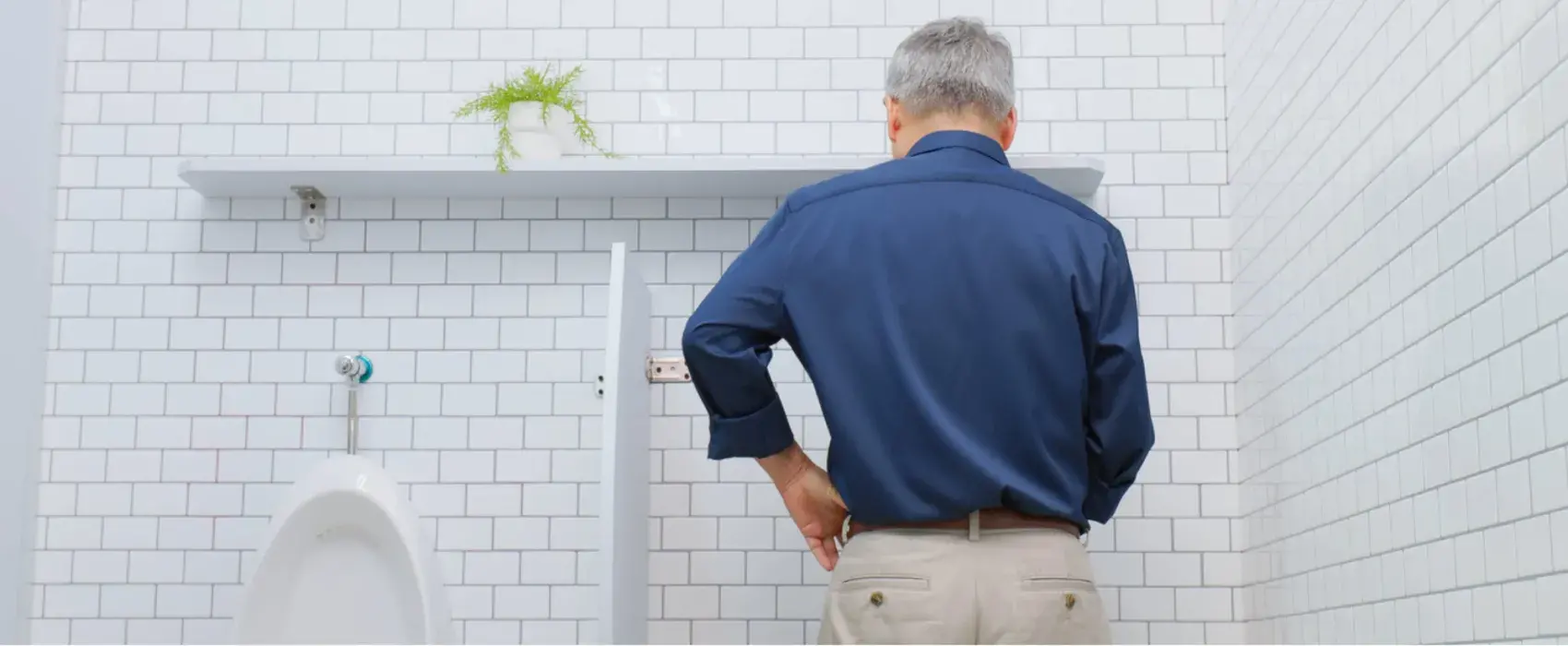 Man using urinal